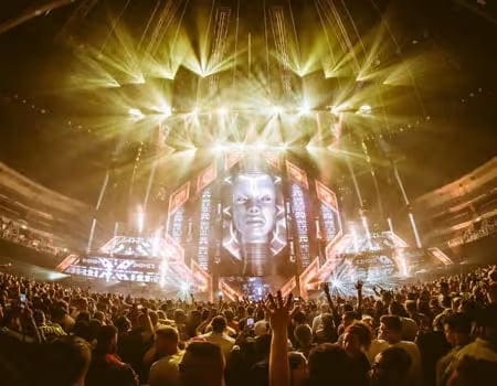 Transmission Behind the Mask stage with immersive lighting and visuals during a live music event.